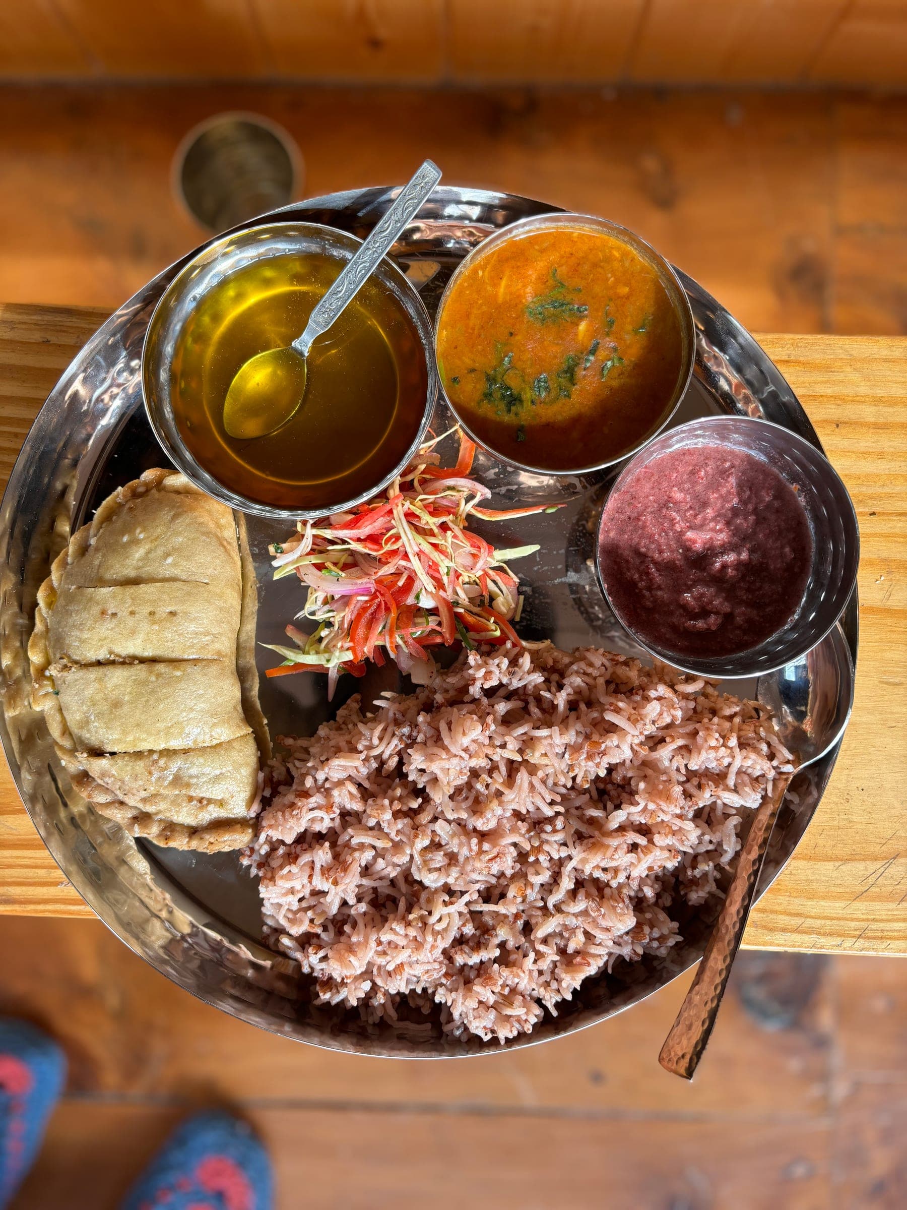 A traditional Himachali thali at Mountain Child Home — dal, sabzi, rice, achar, papad